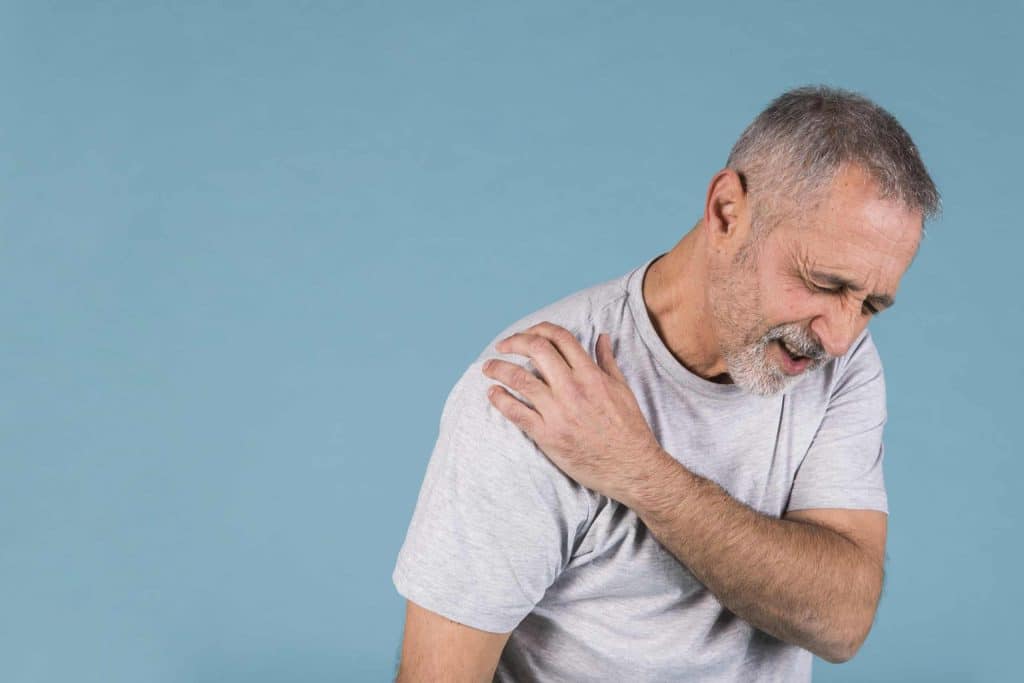 How To Cure Frozen Shoulder Quickly - Elderly Man Holding Shoulder In Pain