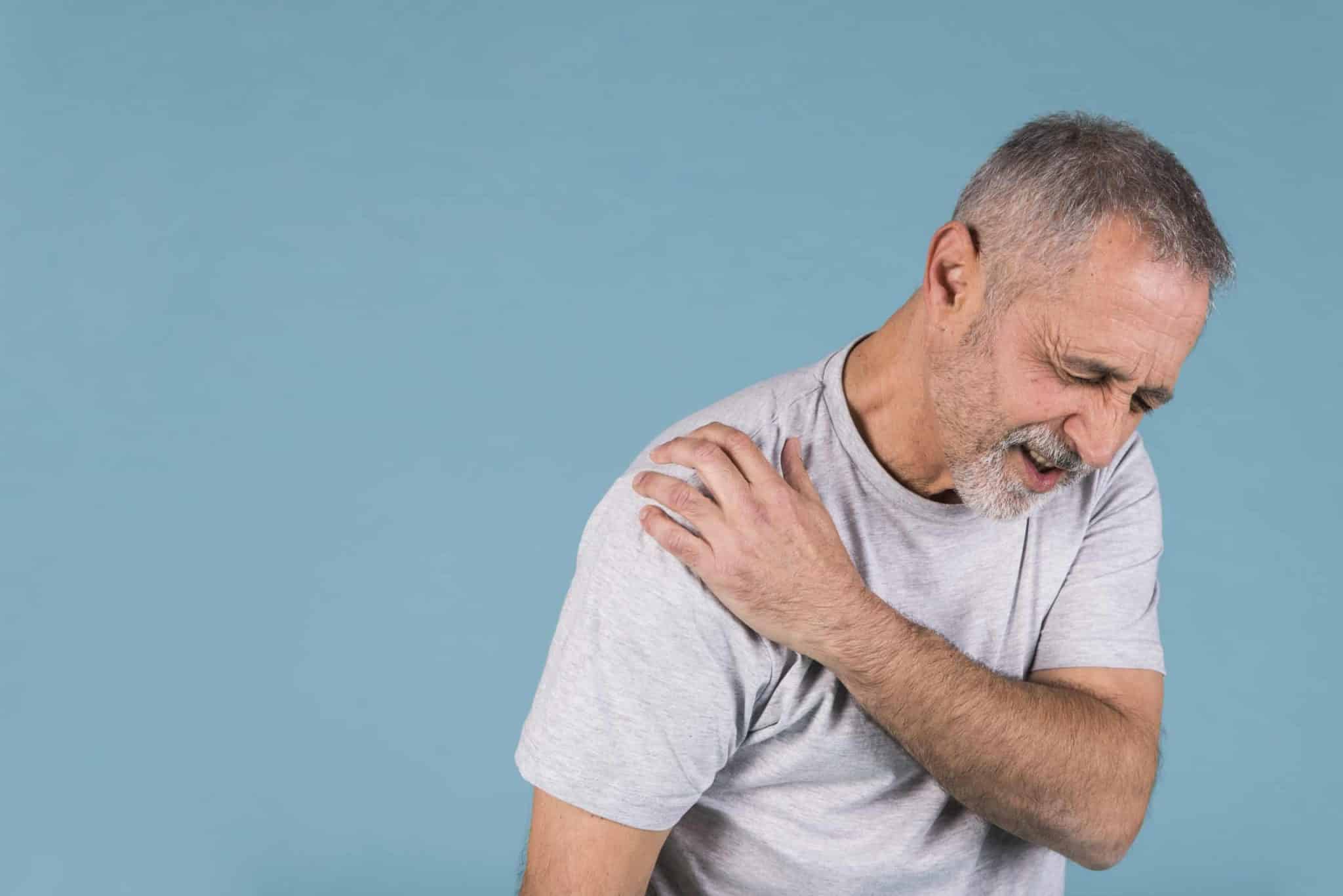 How To Cure Frozen Shoulder Quickly - Elderly Man Holding Shoulder In Pain