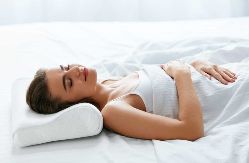 Woman Using Pillow For Neck Pain