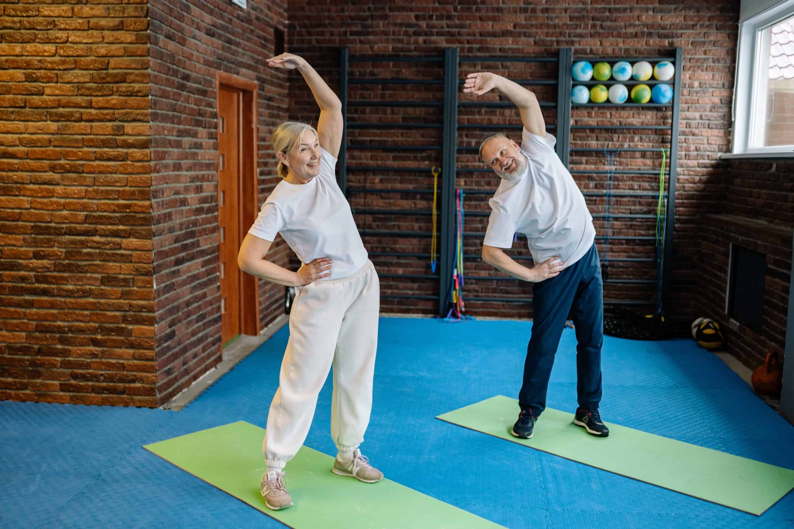 Elderly Couple Exercising In The Gym