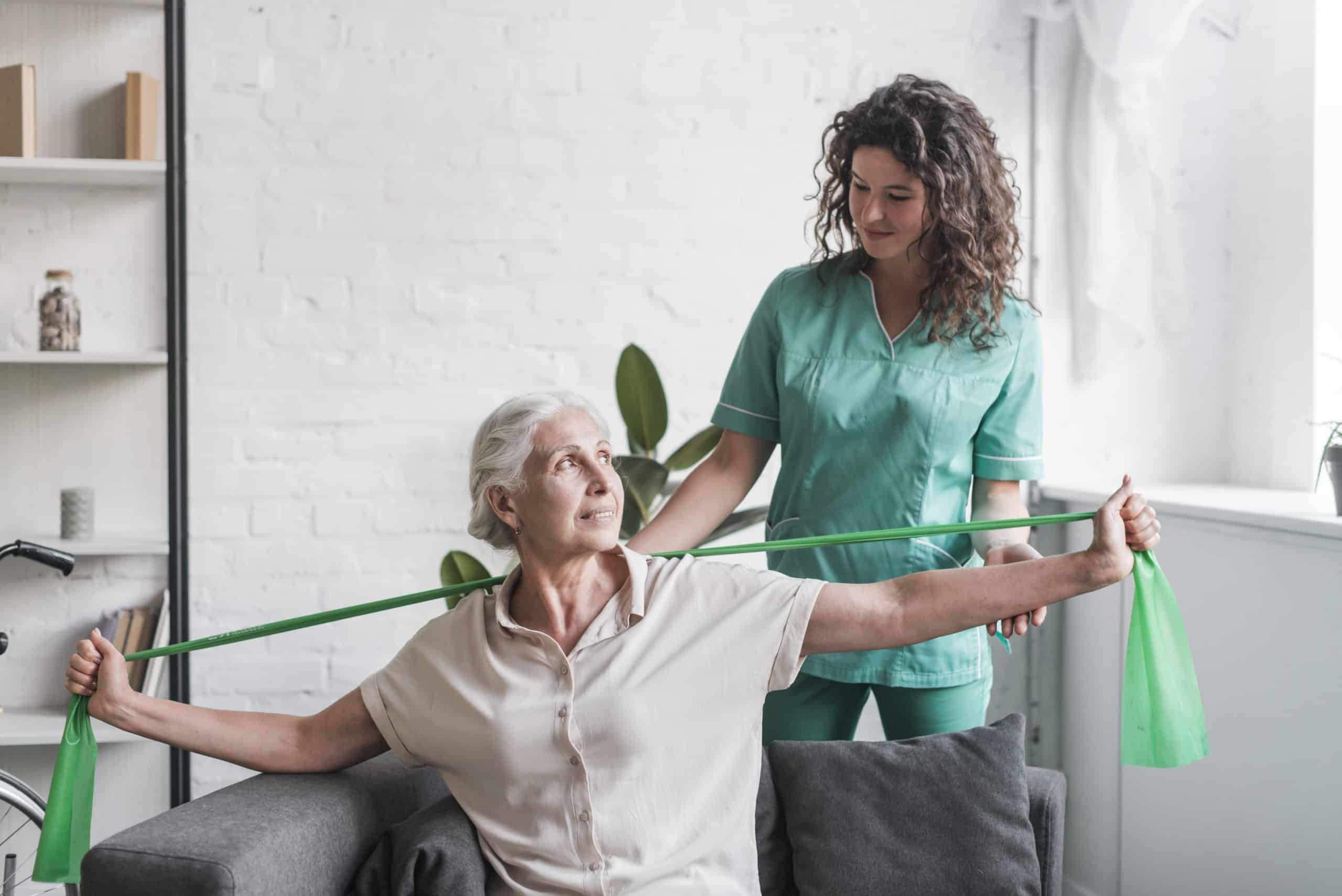 Elderly Woman Exercising With Physiotherapist